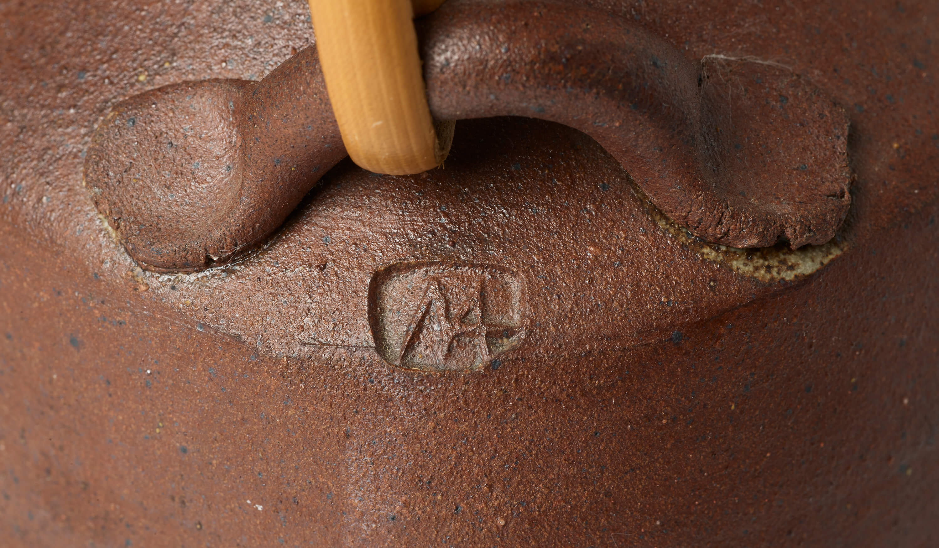 Detail of attached handle. Letter “M” is impressed into the clay. Accession number is visible.